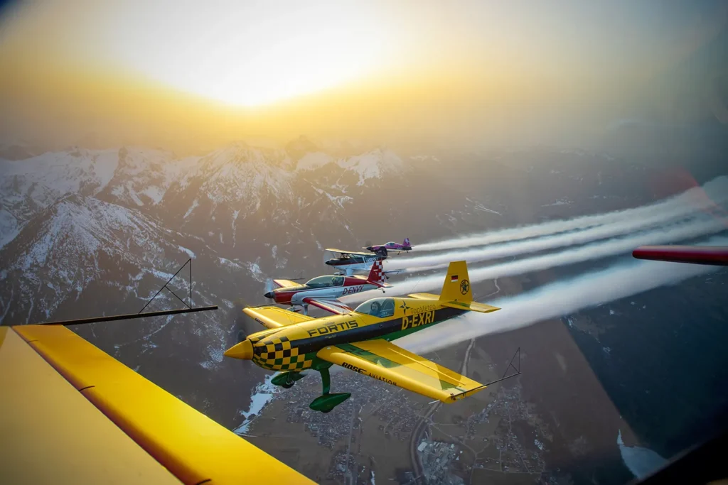 Elisa Bretterebner and the Skytexters 5 aircraft in group with smoke